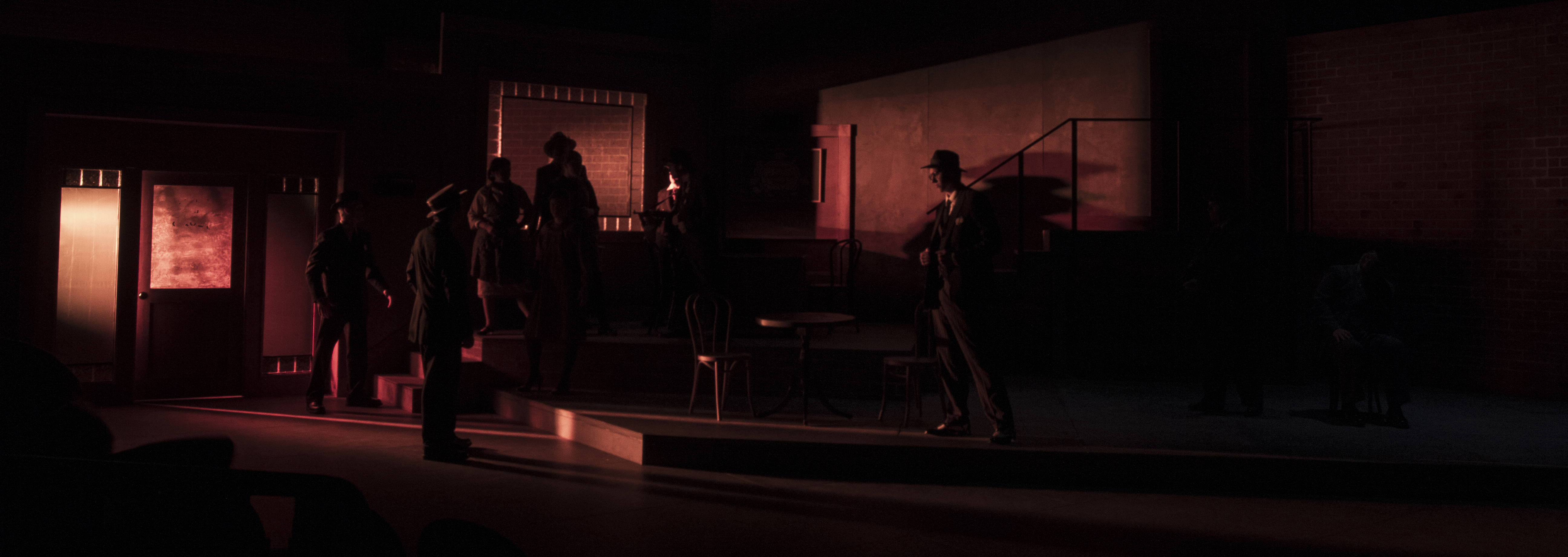 Header Image: The Resisable Rise of Arturo Ui (Dark figures in low red light)